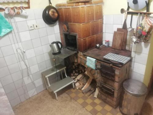 a kitchen with an old fashioned stove in a room at Chata Lužná u Hanušovic 