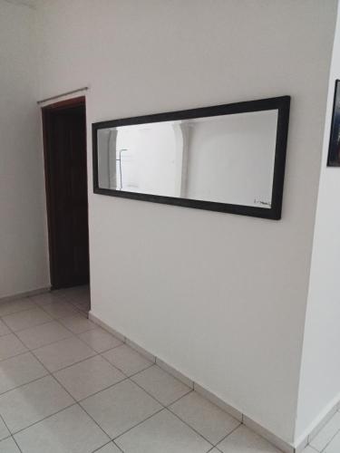 a mirror on a wall in a room at HOMESTAY CAHAYA PUTERI in Tangga Batu