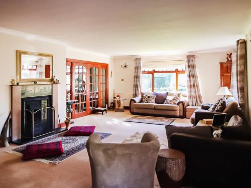 a living room with a couch and a fireplace at Netherley Grange in Peterculter