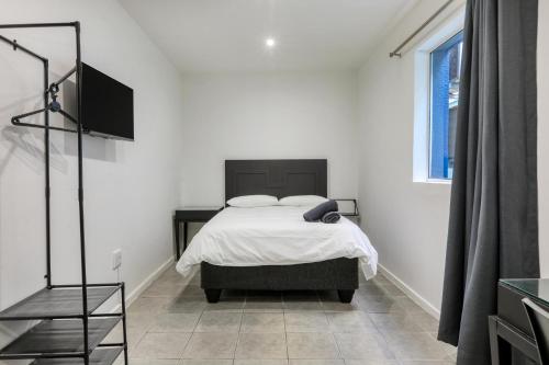 a bedroom with a bed and a television in it at Inn & Out Express Sea Point in Cape Town