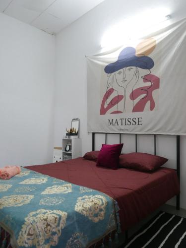a bedroom with a bed with a sign on the wall at little heritage home in George Town