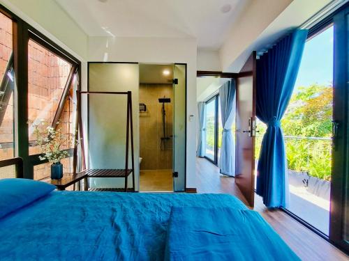 a bedroom with a bed and a large window at Boom Casa Homestay in Hue