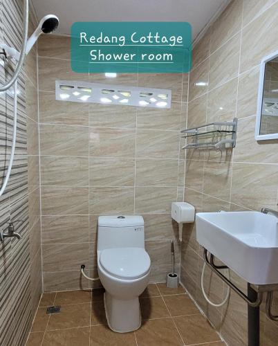 a bathroom with a white toilet and a sink at PULANG RESORT in Setiu