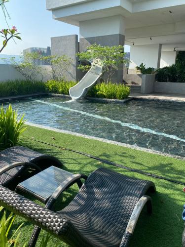 a slide in a swimming pool with a slide at Serini Gateway Melawati in Kuala Lumpur