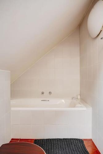 a bathroom with a bath tub and a sink at Le Arc Manor House in Franschhoek