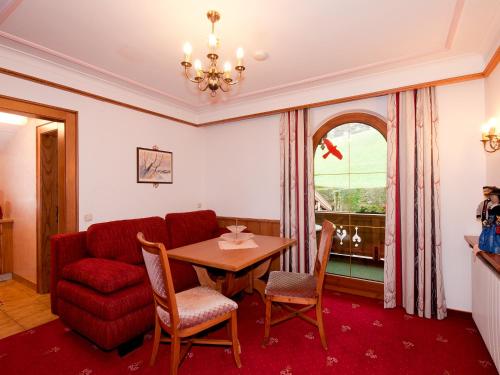 a living room with a table and a couch at Adlerhorst , Gstan 31 in Finkenberg
