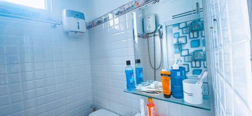 a bathroom with a sink and a toilet and a mirror at Ngõ Saigon Homestay in Ho Chi Minh City