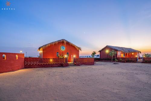 a couple of buildings with lights on them at Zostel Sam Desert (Jaisalmer) in Sām