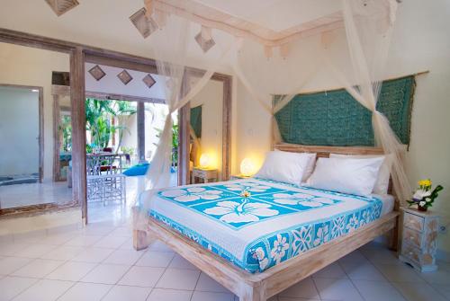 a bedroom with a bed with a canopy at Villa Domus Dua in Seminyak