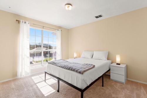 a bedroom with a bed and a large window at Sleep on the Cloud - 5 Bedrooms - Corner Lot in San Antonio