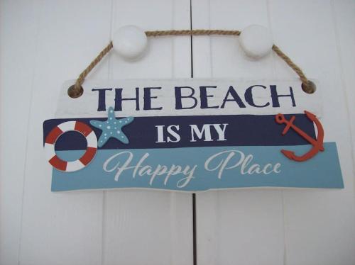 a sign that reads the beach is my happy place at Benvoy House apartment in Annestown