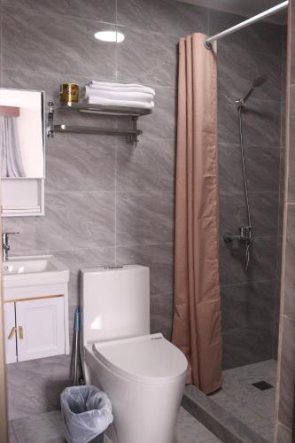 a bathroom with a toilet and a shower at Tinian Lucky Home in Tinian