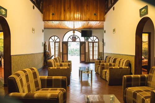 a waiting room with brown chairs and a table at MF Holiday Bungalow in Bandarawela