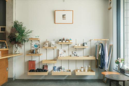 a room with shelves of items on a wall at Okazaki Micro Hotel ANGLE in Okazaki