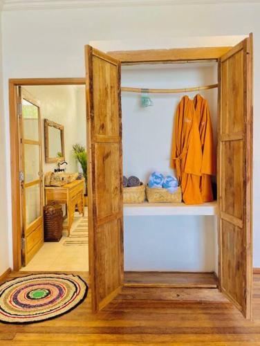 a room with a closet with an open door at La Plage Classique Beachfront Nusa Penida in Nusa Penida