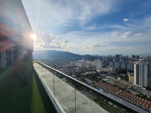 a view of a city from a building with the sun shining at Urban Suites - Penang in Jelutong