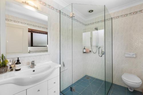 een badkamer met een wastafel en een glazen douche bij Business Or Holiday with Location, Pool, 4 Bedroom in Hamilton