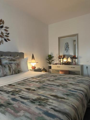 a bedroom with a large bed and a mirror at Eden Luxury in Brăila