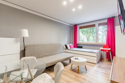a small living room with a couch and a window at Apartament Black Stripes blisko morza in Gdańsk