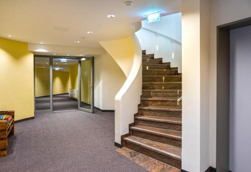 a hallway with stairs in a building at Mosers Blume Relax & Genuss Hotel in Haslach im Kinzigtal