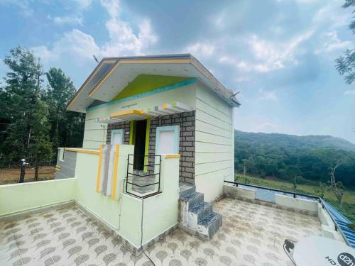 a small house with a balcony on a patio at It’s pleasant vibe with nature oriented in Kolli Hills