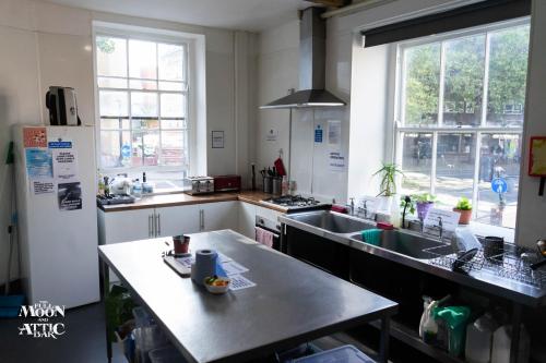 a kitchen with a sink and a refrigerator at The Full Moon Backpackers in Bristol