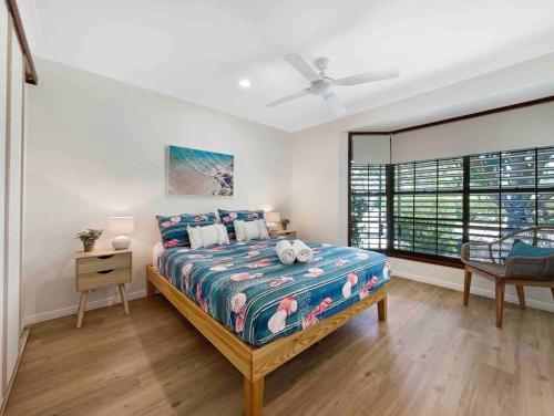 a bedroom with a bed and a window at Absolute Beach Front Home -Dogs, Surf, Relax, Bush in Kawana Waters