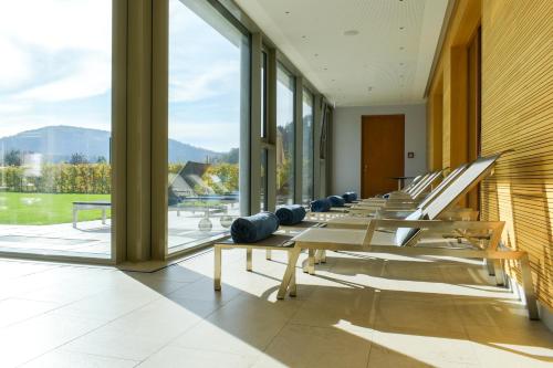 a row of benches in a building with windows at Mosers Blume Relax & Genuss Hotel in Haslach im Kinzigtal