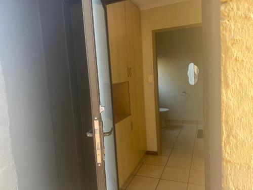 an open door to a bathroom with a toilet at The small-haven in Polokwane