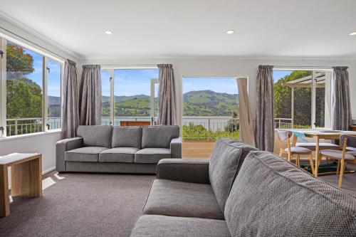 a living room with a couch and a table at Takamatua Holiday Home in Takamatua Bay
