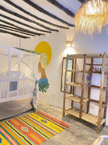 a room with two bunk beds and a ladder at FURAHA BEACH ROOMS in Kendwa
