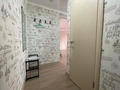 a hallway with drawings on the walls of a room at Квартира целиком с двуспальной кроватью и белым постельным in Petropavlovsk