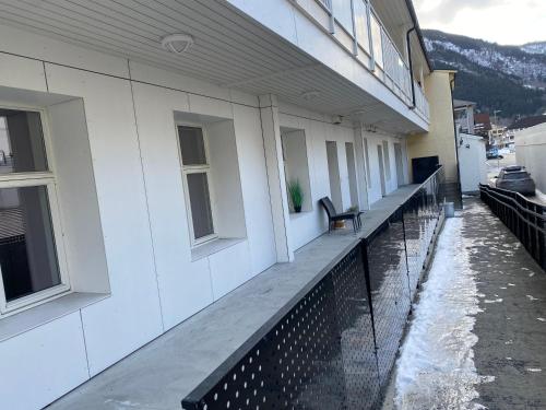 un balcón de un edificio con un banco en Small modern appartment, en Sogndal