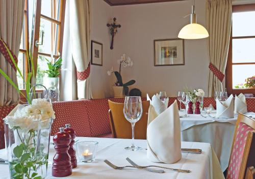 a table in a restaurant with a white table cloth at Mosers Blume Relax & Genuss Hotel in Haslach im Kinzigtal