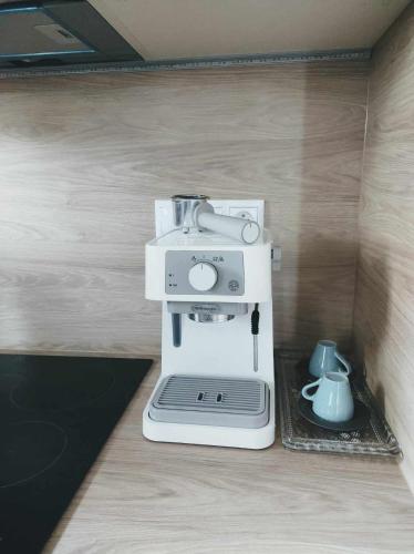 a white sewing machine sitting on top of a counter at Apartment Phoenix in Štôla
