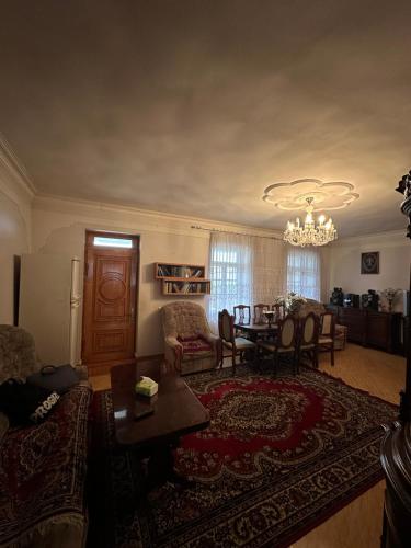 a living room with a table and a dining room at Ijevan beautiful Home in Ijevan