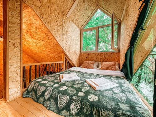 a bedroom with a bed in a tree house at Garemo in Ambrolauri