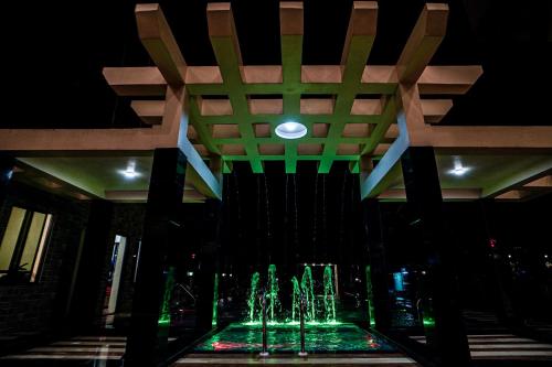 a fountain in the middle of a building at night at Gogol Beach Resort !! Beach 1 Minute !! in Mandarmoni