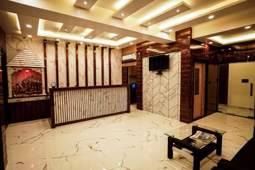 a lobby with marble flooring and a television and a table at Gogol Beach Resort !! Beach 1 Minute !! in Mandarmoni