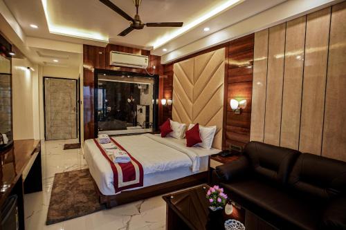 a bedroom with a large bed and a couch at Gogol Beach Resort in Mandarmoni