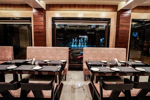 a dining room with tables and chairs and a bar at Gogol Beach Resort !! Beach 1 Minute !! in Mandarmoni