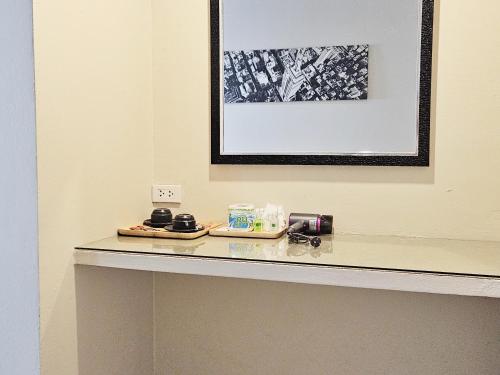 a counter in a room with a picture on the wall at Pacific Residence in Hat Yai