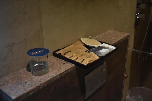 a kitchen counter with a cutting board and a pie at SScoconest Luxury Service Apartments in Chikmagalūr