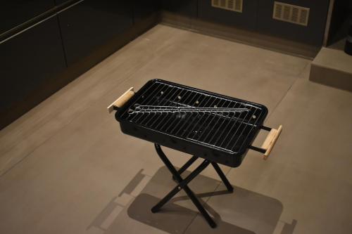 a black grill sitting on a floor in a room at SScoconest Luxury Service Apartments in Chikmagalūr