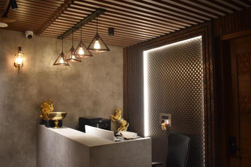 a lobby with a reception desk with lights at SScoconest Luxury Service Apartments in Chikmagalūr