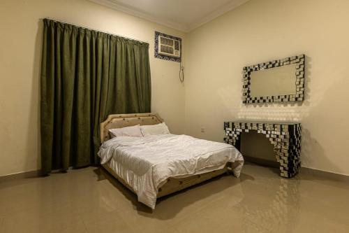 a bedroom with a bed and a fireplace in it at TWO BEDROOM FULLY FURNISHED APARTMENTS in Salalah