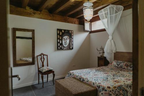 a bedroom with a bed and a mirror and a chair at El Astial 