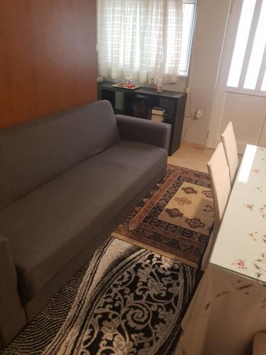 a living room with a couch and a rug at The Quiet Corner in Kalamata