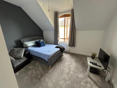 a small bedroom with a bed and a window at Hayward mews holiday homes in Swords in Swords