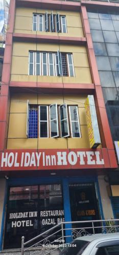 um edifício de hotel com um sinal para um hotel em Holiday Inn em Kakarvitta